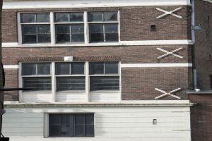 Ein Gebäude mit mehreren Fenstern und sichtbaren Rohren an seiner Außenseite.
