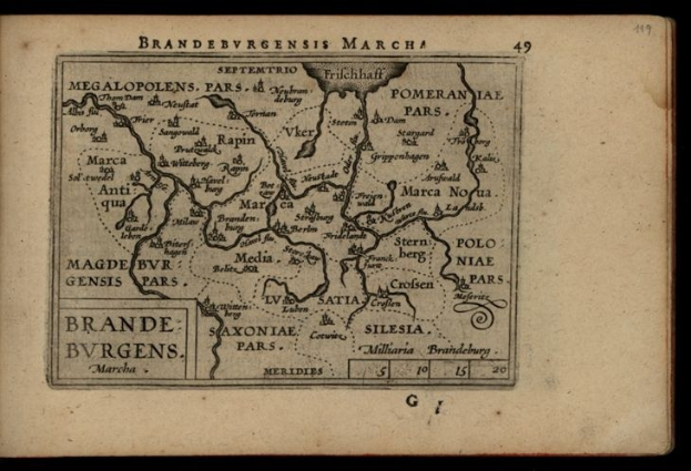 Altes Buch mit einer detaillierten Karte der Brandenburg-Region Deutschlands auf einem schwarzen Hintergrund, das geografische Merkmale und Text über die Region enthält.